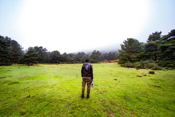 Adventurous wildlife photographer exploring a rainy autumn day in Peguerinos, Sierra de Guadarrama.
