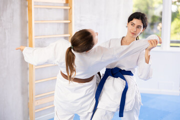 Karate practitioners showcase their techniques in dynamic sparring session, focusing on speed and...