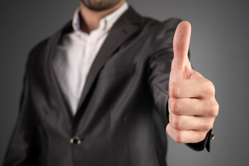 Man in suit showing thumbs up