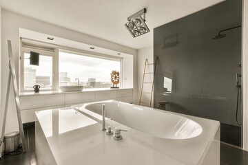 a modern bathroom with black walls and white fixtures in the bathtub is next to a window that looks out onto the citysca