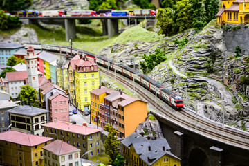view of the train coming around the mountain in a model railway of alpine village