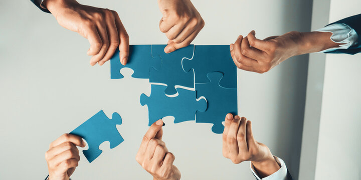 Top view panorama banner of business team assembling jigsaw puzzle over table symbolize business partnership and collective teamwork for HR recruitment and job seeker background. Shrewd