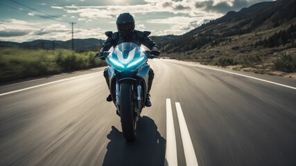 a person riding a motorcycle on a road with mountains in the background