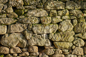 wall of irregular granite stone blocks, texture for background
