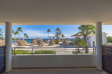 Interior view of hotel room balcony with stunning Caribbean sea view in Curacao, providing tranquil...
