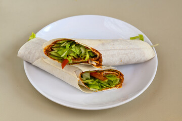Cig kofte (raw meatball) with lettuce, tomato, pickle and lemon, hot Chee kofta. Turkish local raw food concept.Table scene of assorted take out or delivery foods. Top view of assorted Turkish food.