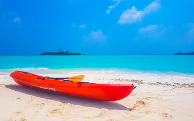 Canoe boat on white sand turquoise sea Rasdhoo island Maldives.