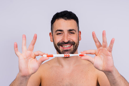 Brush teeth everyday. Masculine model happy to care of oral hygiene, toothbrush, Sanitary concept
