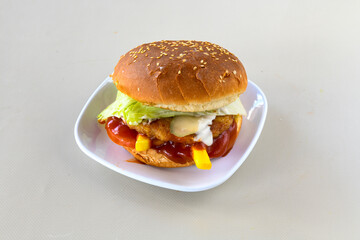Big tasty burger, hamburger  with beef cutlet on a plate. Crispy chicken burger.