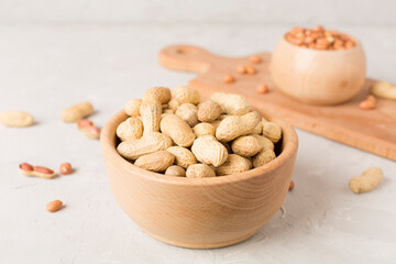 Peeled and unpeeled peanuts on concrete table