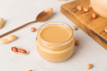 Bowl of peanut butter isolated on white background, top view