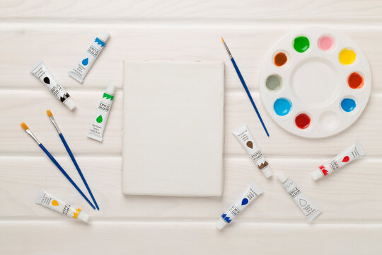 Painting tools on wooden background, top, view