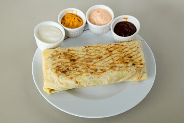 Lavash doner kebab ( zurna doner durum )  or shawarma sliced in plate isolated.  Tavuk Et Doner Durum. Hatay usulu tavuk doner durum. 
