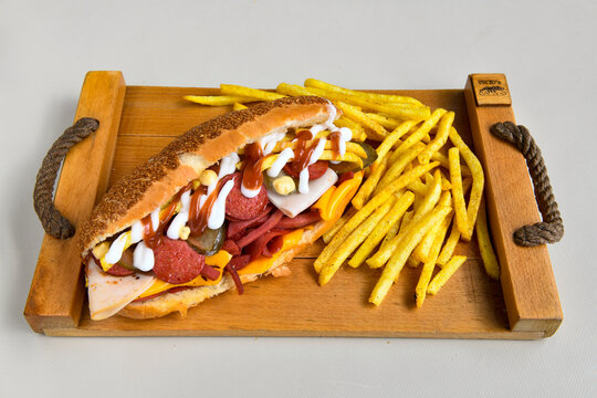 Close-up shot of Izmir's famous Turkish Traditional Kumru Sandwich, &Ccedil;eşme Kumru , ingredients ready to eat salami, sucuk , tomato, cheddar cheese and fried cheese. Yengen eritme karisik sandvic.