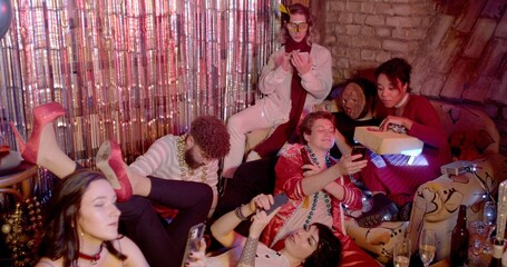 Text messages while hangout friends, online texting detriment live communication. A lot of people lie on the sofa relax use phones during party. No being physically and emotionally involved company. 