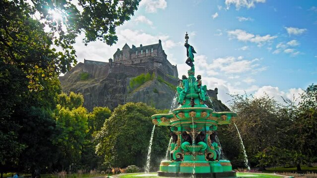 Panoramic view of Ross Fountain in Edinburgh, Scotland. Garden-side, cast-iron fountain representing science, arts, poetry and industry with Edinburgh Castle in the background.

