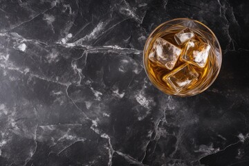 Whiskey on rocks atop black table seen from above with space