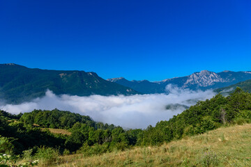 Beautiful mist over green forest on mountain. Fog in the valley. The morning mist  in Bosnia and Herzegovina.