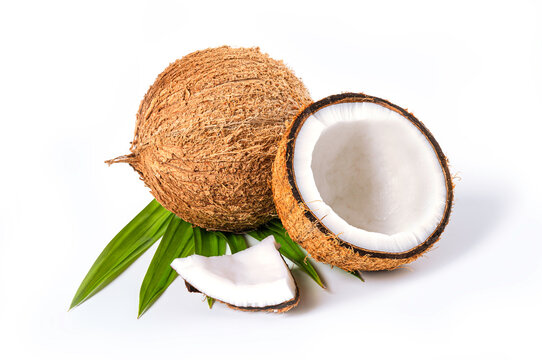 Coconut with half and leaves isolated on white background.