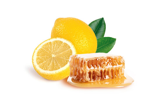 Honey comb with lemon and leaves isolated on white background.