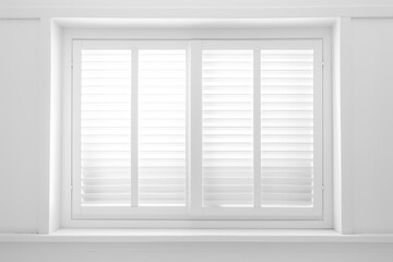 window with white shutters on a white wall