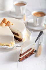 Delicious white chocolate cake with brownie, glaze and white chocolate.
