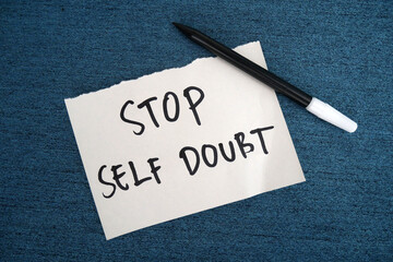 Handwritten message paper STOP SELF DOUBT, concept of self worth , stop striving for approval, more...