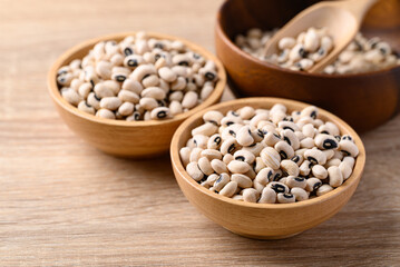 Black eye peas or cowpeas in bowl on wooden background, Food ingredients