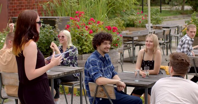 Host of the event explains the rules to participants. Speed dating is a social event or dating activity where people meet a large number of potential partners or dates in a relatively short period.