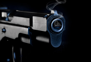 9mm semi-automatic pistol on a black background with a closeup of the barrel.