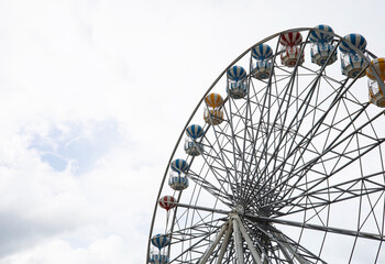 Ferris wheel at the festival theme park on an overcast day.