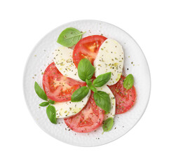 Plate of delicious Caprese salad with herbs isolated on white, top view