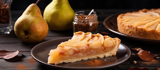 Autumn dessert consisting of homemade pear tart with pieces of this scrumptious fruit pie seen on a...