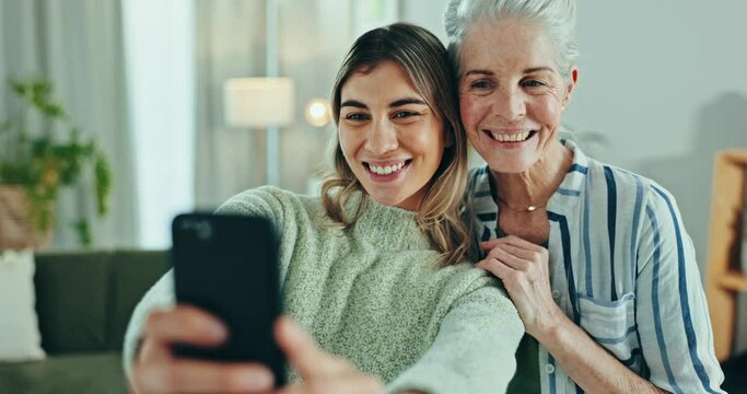 Selfie, love and woman with senior mother in a living room with memory, moment or bond. Phone, profile picture and female person with elderly mom in a living room pose for social media, blog or post
