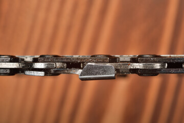 Closeup on chain saw link top view. Chainsaw cutting tooth. Sharp cutting tool.