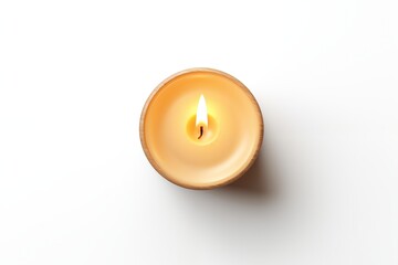 Obraz na płótnie Canvas Burning wax candle on white background, top view.
