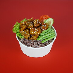 Chicken cuisine with black rice and veggies in rice bowl