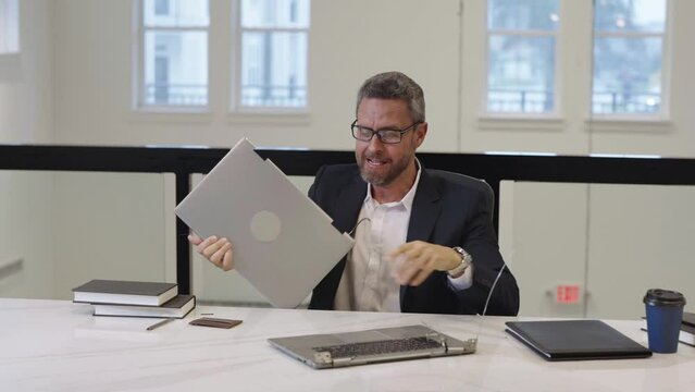 Angry boss broken laptop in office. Businessman broken laptop. Angry stressed business man crashing laptop. Bad angry man in suit broken laptop. Business problem. Furious crazy man broken office pc.