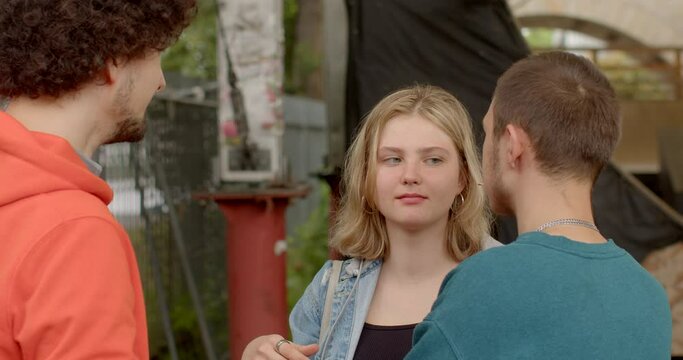 People eating pizza. Girl kisses the guy. Lifestyle. Polyamory is relationship style in which individuals have consensual and open romantic sexual relationships with multiple partners simultaneously.