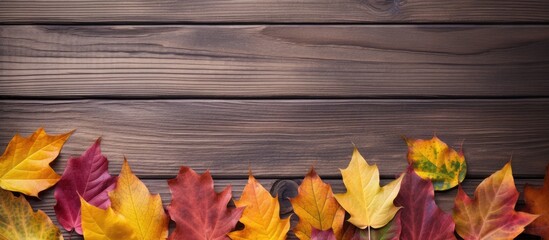 A wooden board serves as the canvas for a picturesque scene featuring vibrant autumn leaves as the backdrop