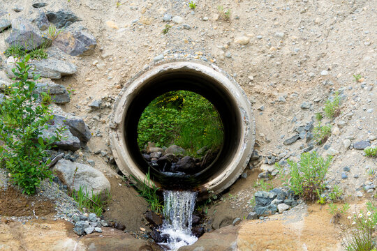 A close up image of a large concrete culvert redirecting waste water run off.