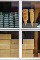 Odense, Denmark A window of an ice cream shop with stacked ice cream cones.