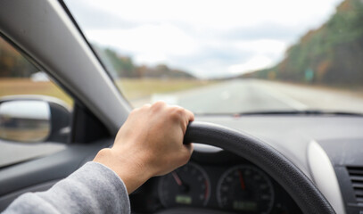 hands gripping a steering wheel, symbolizing control, focus, and safety while driving