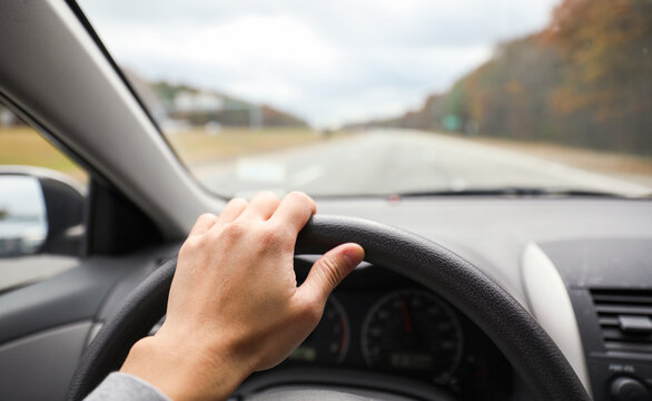 hands gripping a steering wheel, symbolizing control, focus, and safety while driving