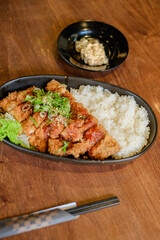 Chicken Katsu Curry is a dish of crispy chicken pieces served over rice with Japanese curry sauce.