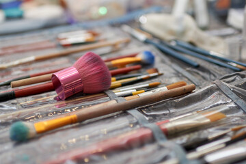 Obraz premium Group of paintbrushes with flat and round tips, Variety of well-worn flat and round brushes, Paintbrush set featuring flat and round brushes,