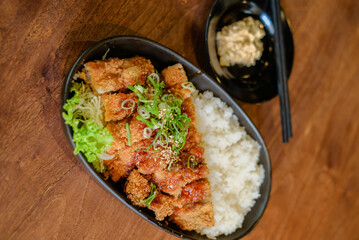 Chicken Katsu Curry is a dish of crispy chicken pieces served over rice with Japanese curry sauce.