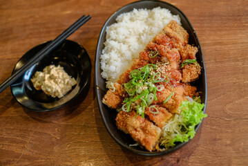 Chicken Katsu Curry is a dish of crispy chicken pieces served over rice with Japanese curry sauce.