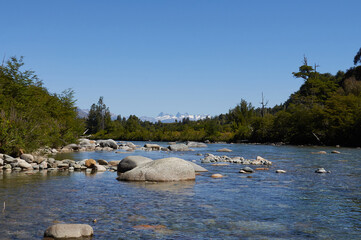 Blue River Amidst Rocks and Black Forest, Rio Negro Patagonia - Argentina