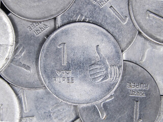 closeup top view shot of rare old vintage indian 1 or one rupee shiny silver coins in a messy mixed...